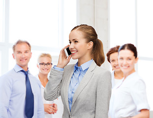 Image showing young smiling businesswoman with smartphone