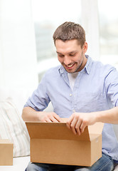 Image showing man with cardboard boxes at home