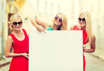 Image showing three happy blonde women with blank white board