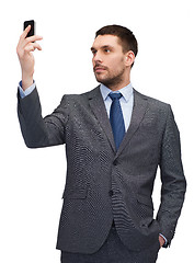 Image showing young businessman with smartphone