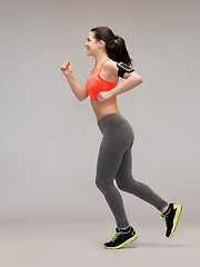 Image showing sporty woman running or jumping