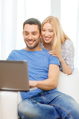 Image showing smiling happy couple with laptop at home