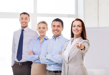 Image showing businesswoman in office pointing finger at you