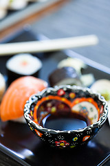 Image showing Bowl soy sauce on sushi plate