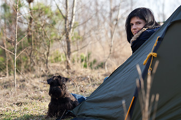 Image showing Woman with a dog camping