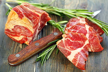 Image showing Meat and sprigs rosemary closeup.