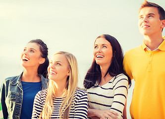 Image showing group of friends looking up on the beach