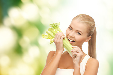 Image showing woman biting piece of celery or green salad