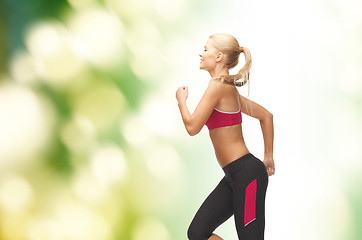 Image showing sporty woman running or jumping