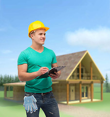 Image showing smiling man in helmet with clipboard