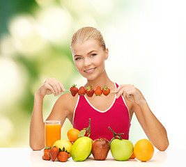 Image showing smiling young woman with organic food on the table