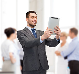 Image showing smiling buisnessman with tablet pc computer