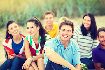 Image showing group of friends looking up on the beach