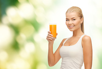 Image showing smiling woman holding glass of orange juice