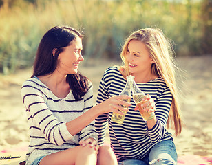 Image showing girls with drinks on the beach