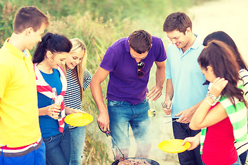 Image showing group of friends having picnic on the beach