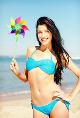 Image showing girl with windmill toy on the beach