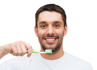 Image showing smiling young man with toothbrush