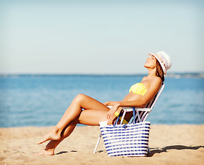 Image showing girl sunbathing on the beach chair