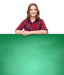 Image showing smiling young teenage girl with white blank board