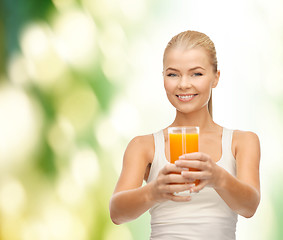 Image showing smiling woman holding glass of orange juice