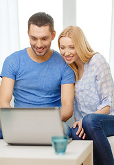 Image showing smiling happy couple with laptop at home