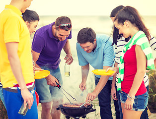 Image showing group of friends having picnic on the beach