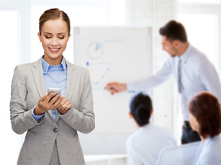 Image showing young smiling businesswoman with smartphone