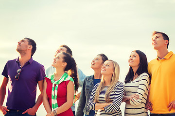 Image showing group of friends looking up on the beach