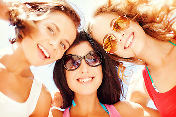 Image showing girls faces with shades looking down