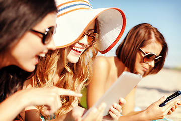 Image showing girls with tablet pc on the beach