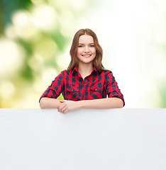 Image showing smiling young teenage girl with white blank board