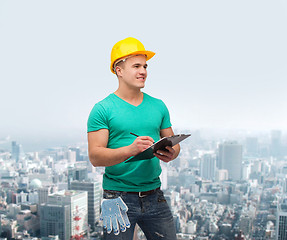 Image showing smiling man in helmet with clipboard