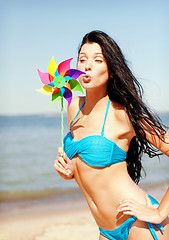 Image showing girl with windmill toy on the beach