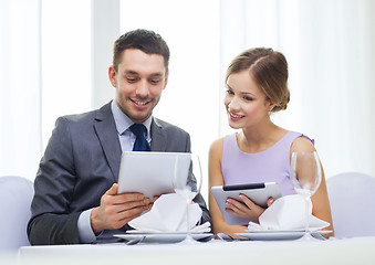 Image showing couple with menus on tablet pc at restaurant