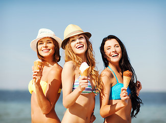 Image showing girls in bikinis with ice cream on the beach