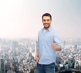 Image showing smiling man showing thumbs up