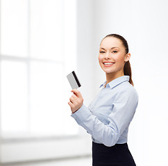 Image showing smiling businesswoman showing credit card