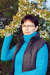 Image showing happy smiling middle age woman outdoor with tree