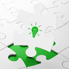 Image showing Business concept: Light Bulb on puzzle background