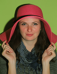 Image showing Brunette posing with pink hat