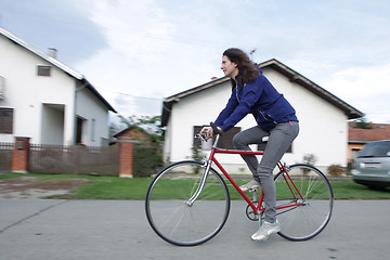 Image showing Young woman cycling