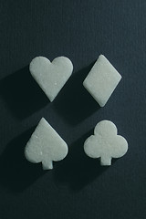 Image showing sweet sugar - club, spades, diamond, heart on blue background