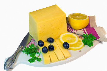 Image showing Big piece of cheese, lemon and olives on a white background.
