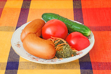 Image showing Two big sausages and vegetables on a white dish.
