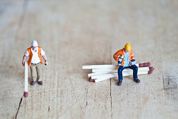 Image showing Miniature people in action with matchsticks