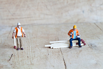 Image showing Miniature people in action with matchsticks