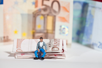 Image showing Miniature people in action with euro banknotes