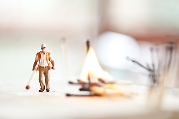 Image showing Miniature people in action with matchsticks