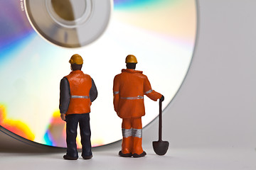 Image showing Miniature people in action with CDs